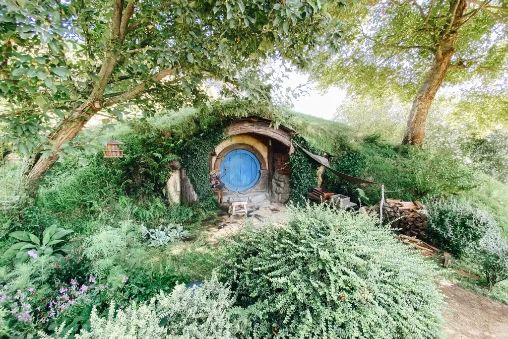 Hobbiton garden, flowers and blue door.