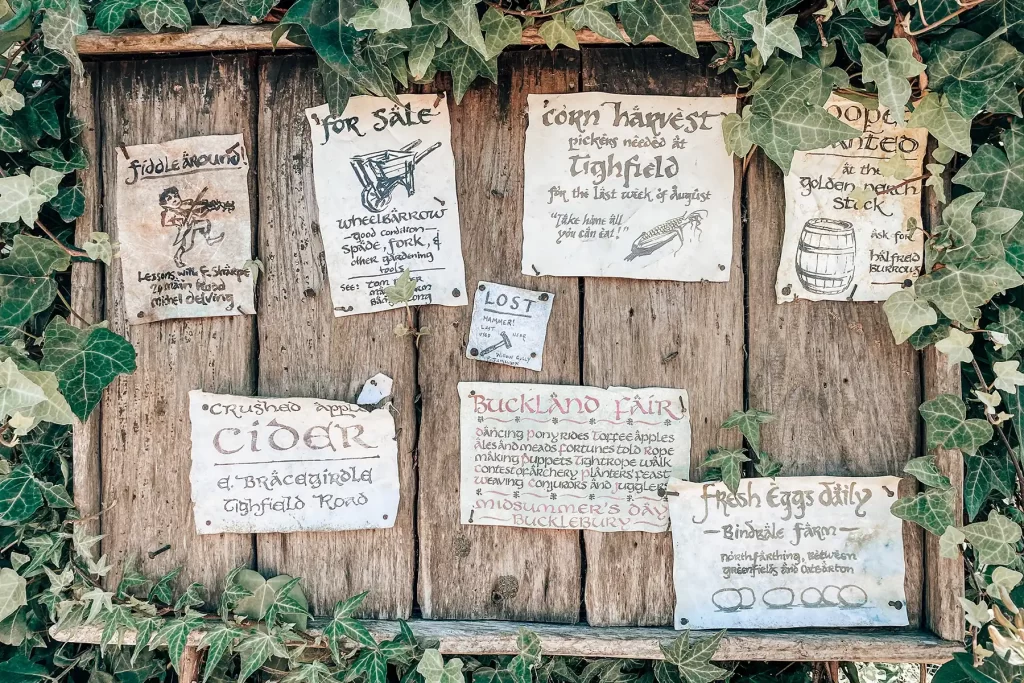 Hobbiton sign with posters.