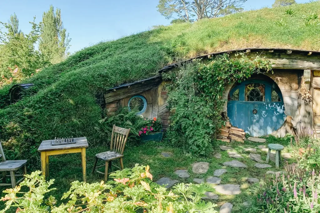Hobbiton garden, chess set and blue door.
