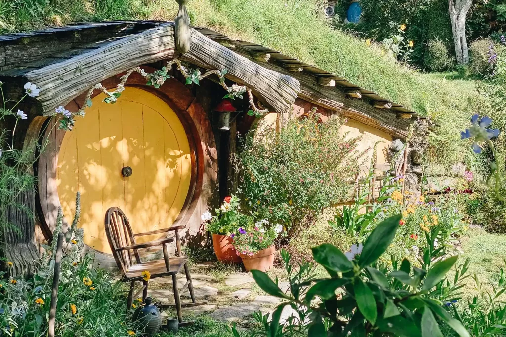 Hobbiton garden, chair and yellow door.